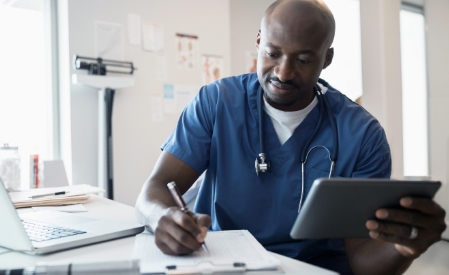 Man holding a tablet, filling out a form